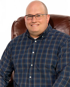 Photograph of appraiser John Leonard seated in a chair